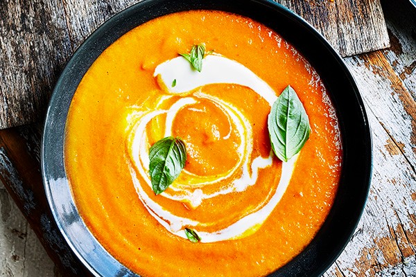A bowl of tomato soup, with a swirl of creme fraiche