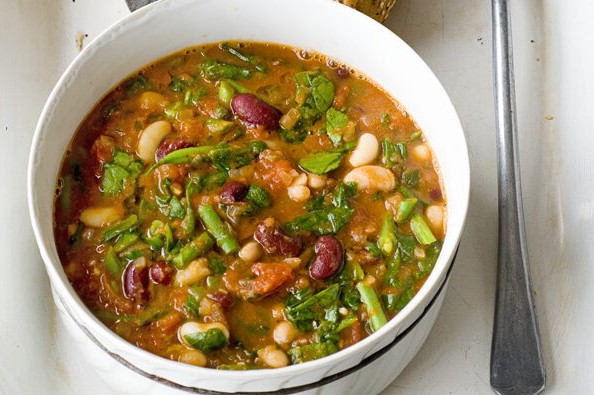 Vegetable and bean stew in a pot with bread