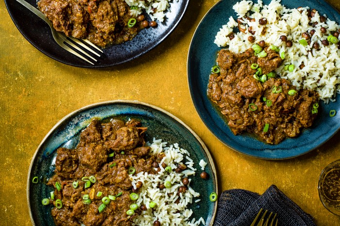 three bowls of pork curry with rice and peas