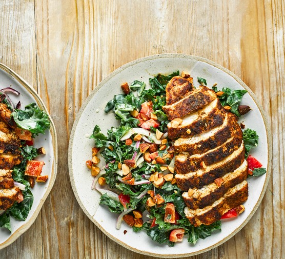Cumin-Crusted Chicken with Kale Salad on two Plates