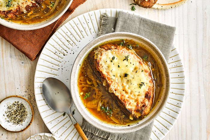 A bowl of French onion soup with cheese on top