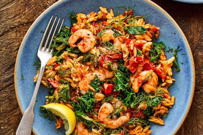 Baked Orzo with Harissa Prawns and Lemon on a Blue Plate