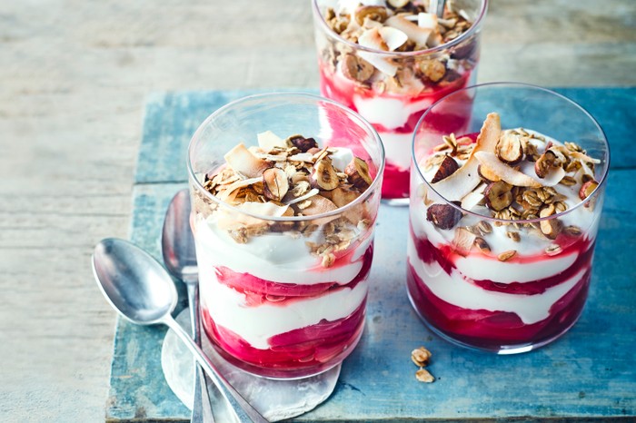 Rhubarb breakfast pots with granola topping served on a tray