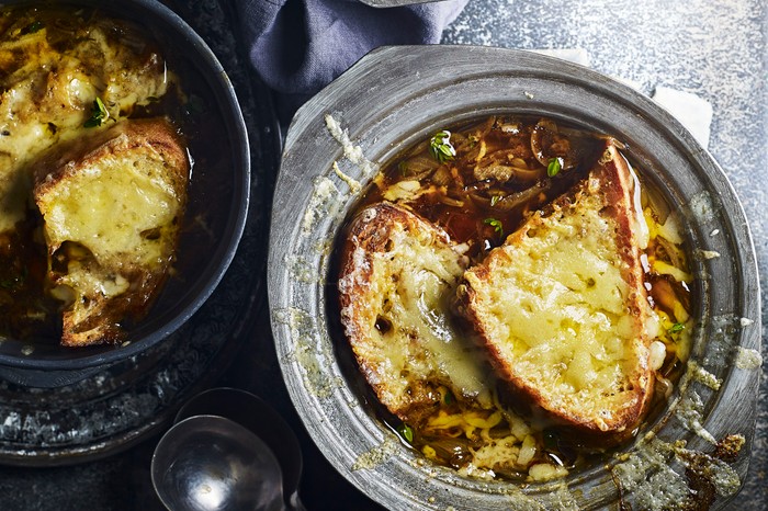 Two bowls of French onion soup, topped with cheese toastie