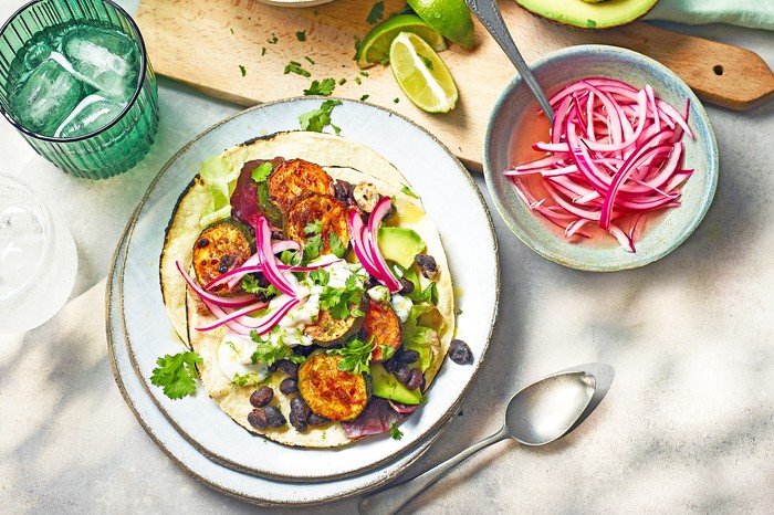 Taco Topped with Sliced Charred Courgette, Black Beans and Red Onion